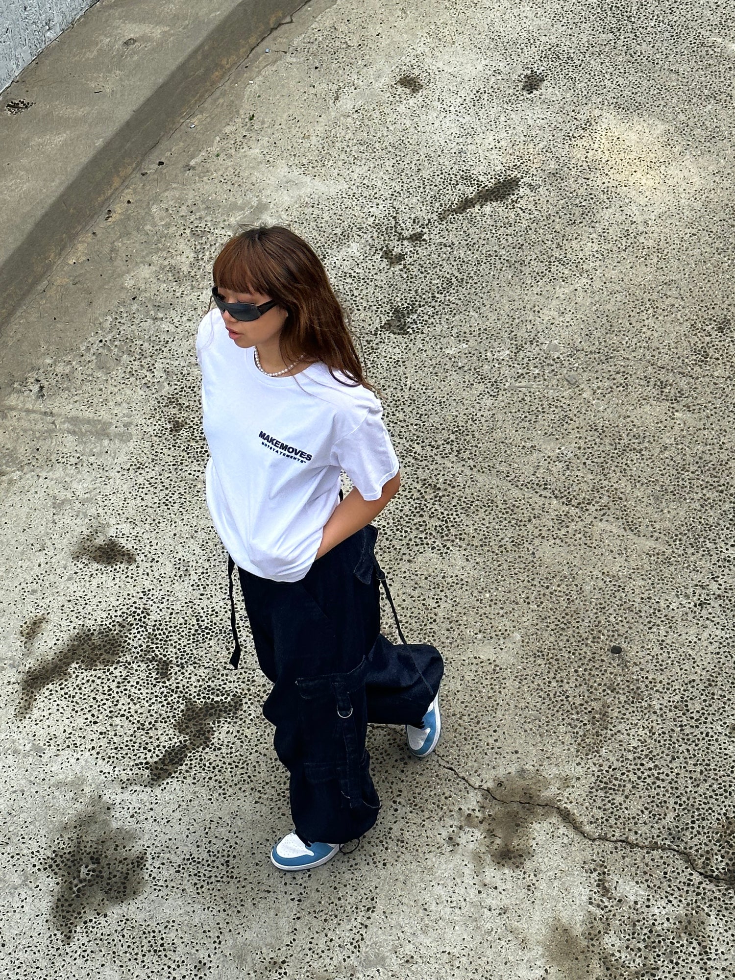 Make Moves Not Statements Basic White Tee is styled by woman with joggers & tennis shoes.