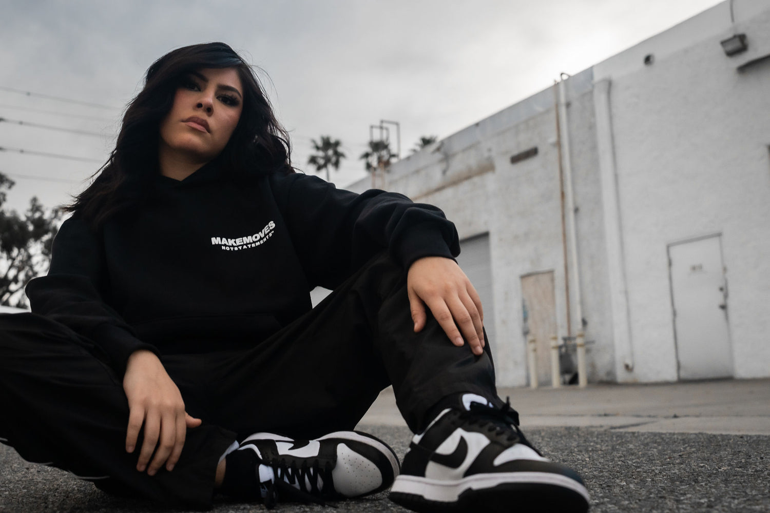 Make Moves Not Statements Luxury LA Hoodie is worn by urban fashion woman styled with Nike and joggers.