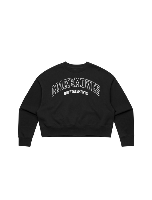The Make Moves Not Statements long sleeve sport crop top is 100% cotton, french terry. The crop top features a large MMNS logo  across  the front in white outlined font.  